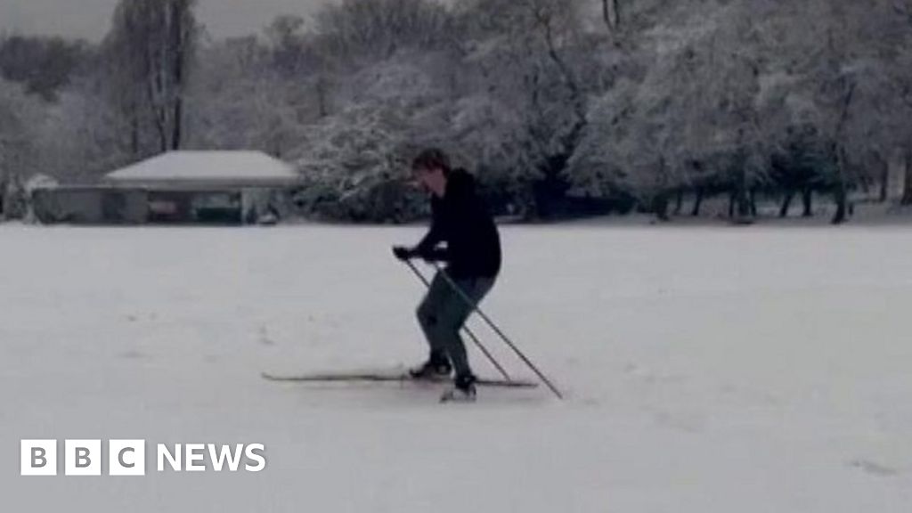 Man skis through park as snow hits London