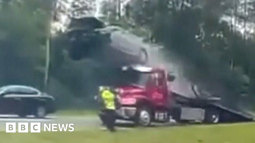 Watch car fly off tow truck ramp on US motorway
