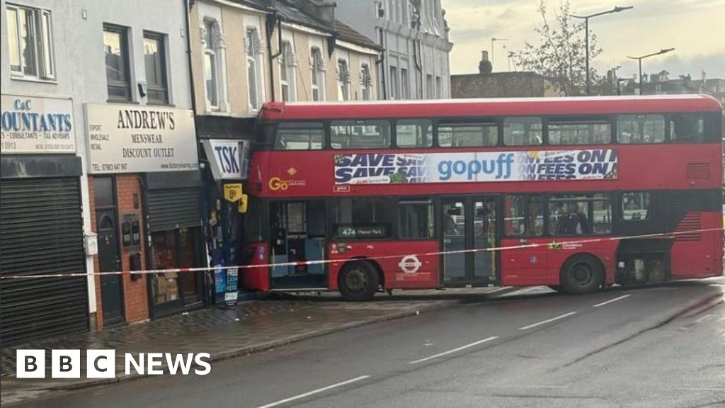 Bus crashes into shop in east London