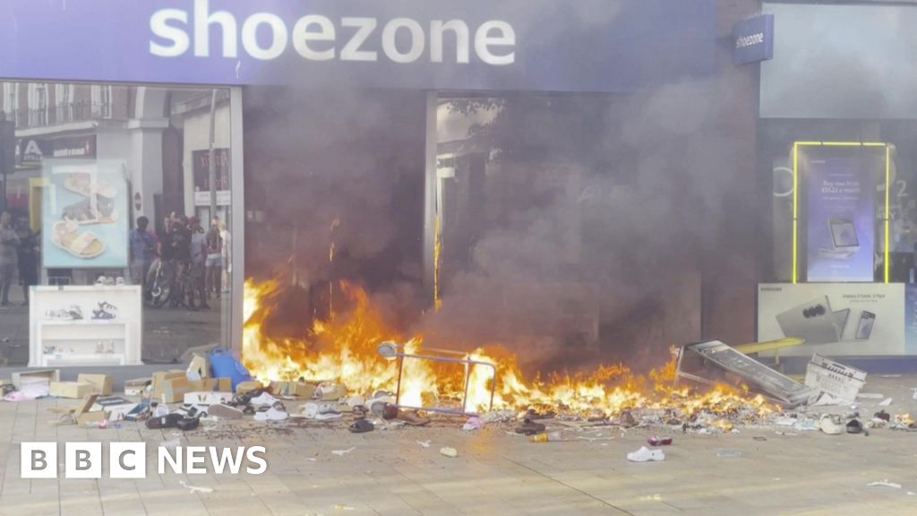 Cars and shop torched in violent UK protests