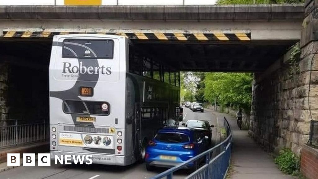 School bus gets stuck under low bridge again