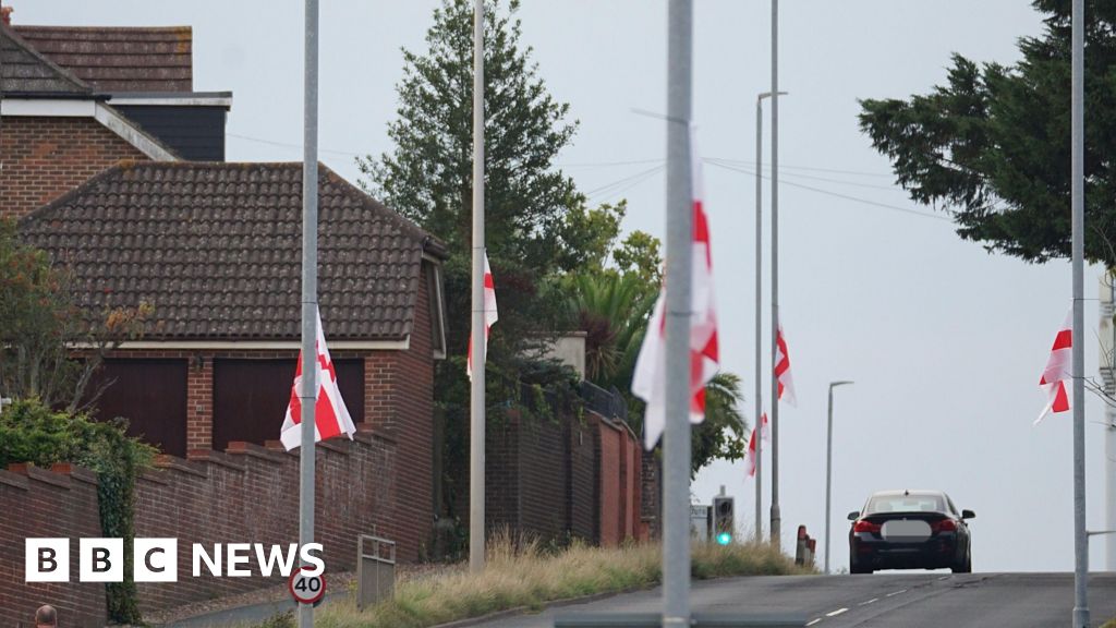 St George's Cross flags line a suburban street.