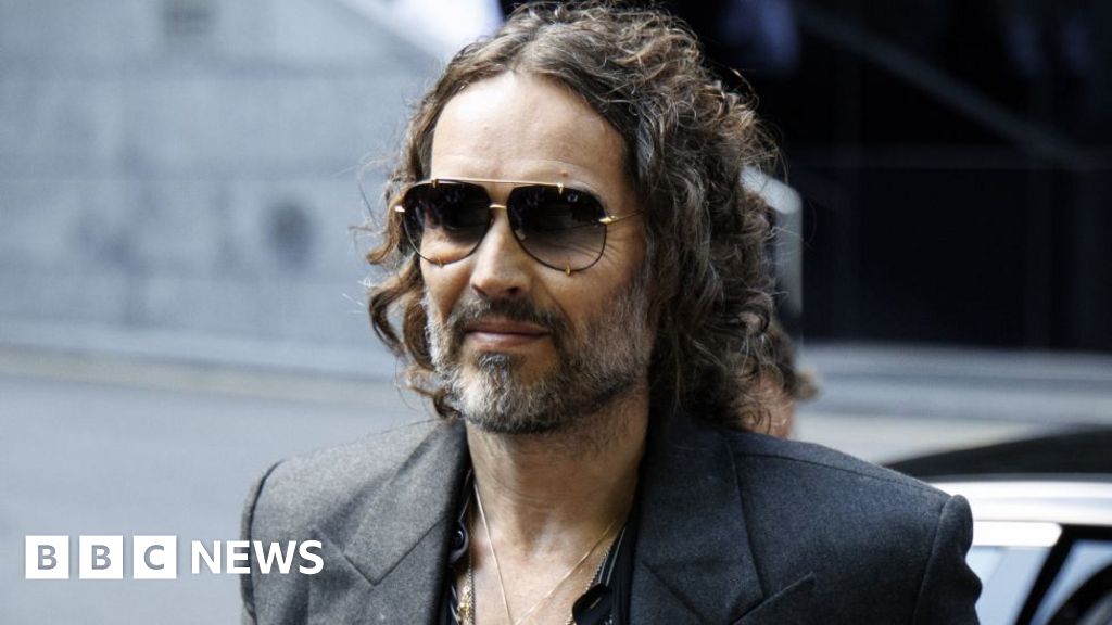 Russell Brand arrives at court to answer rape and assault charges