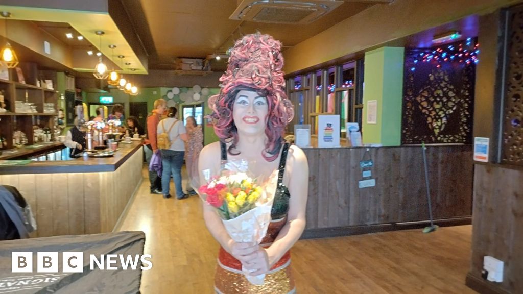 Aida H Dee holding flowers after her performance