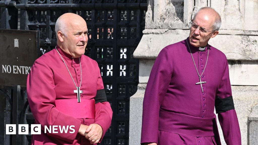 Archbishop of York Stephen Geoffrey Cottrell (left) and The Archbishop of Canterbury Justin Welby outside Westminster Hall, London. They are wearing robes and have a cross hanging around each of their necks.