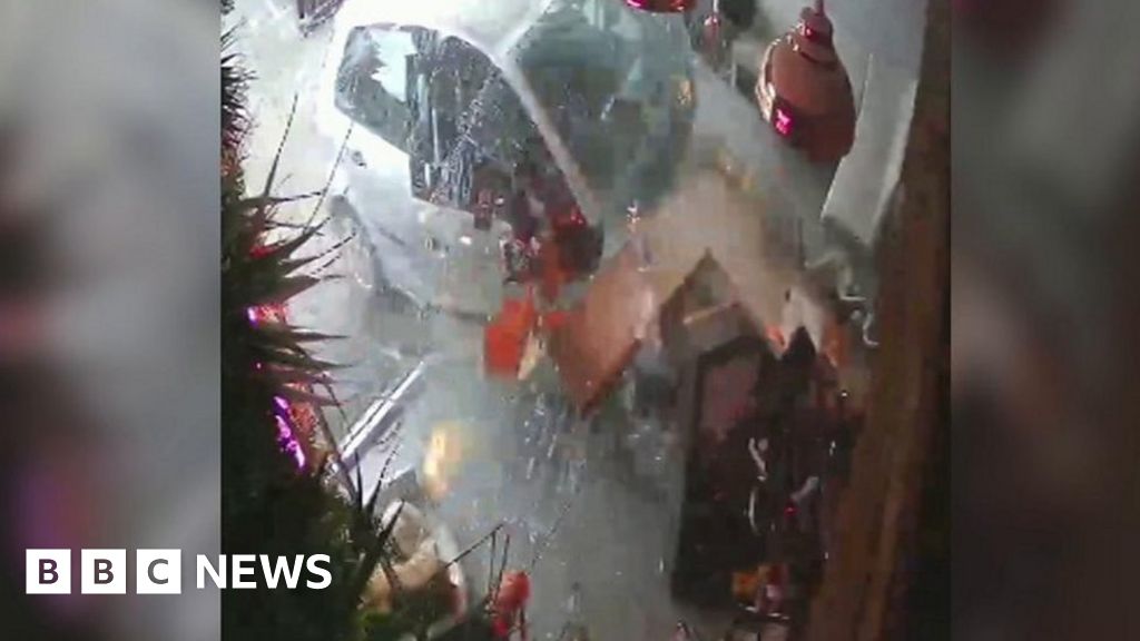 The moment car smashes into tanning shop
