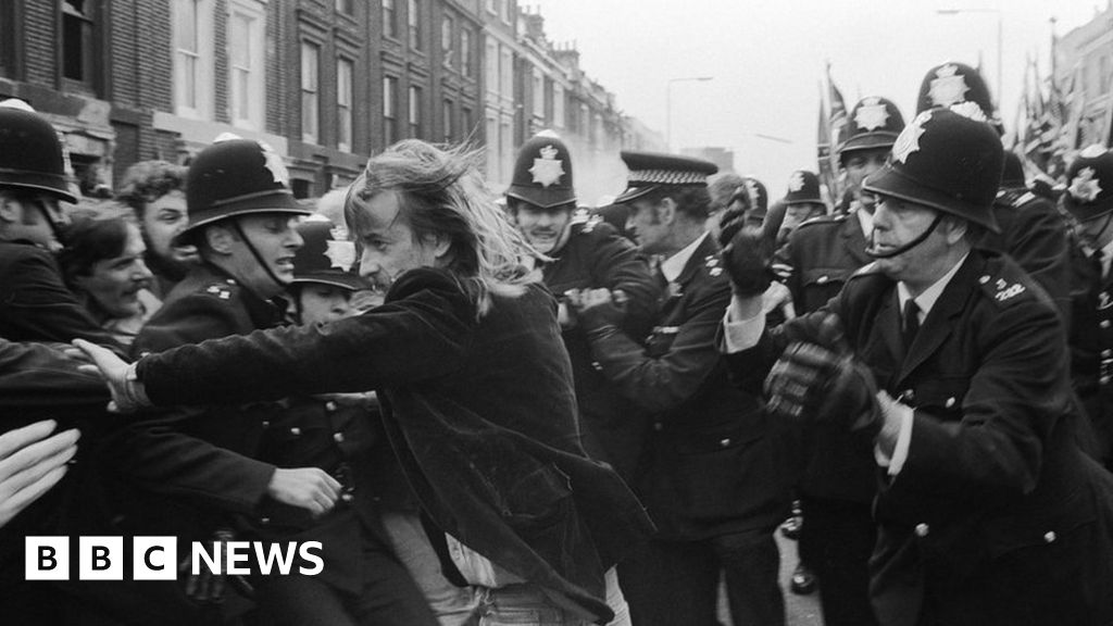 A left wing demonstrator called Robert Johnson tries to break through a police cordon