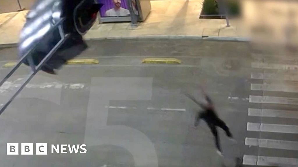 Moment skydiver crash lands onto traffic light