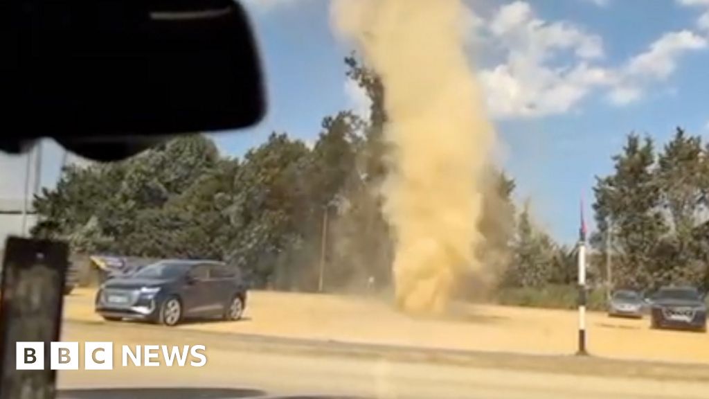 Dust devil whirls through farm shop car park