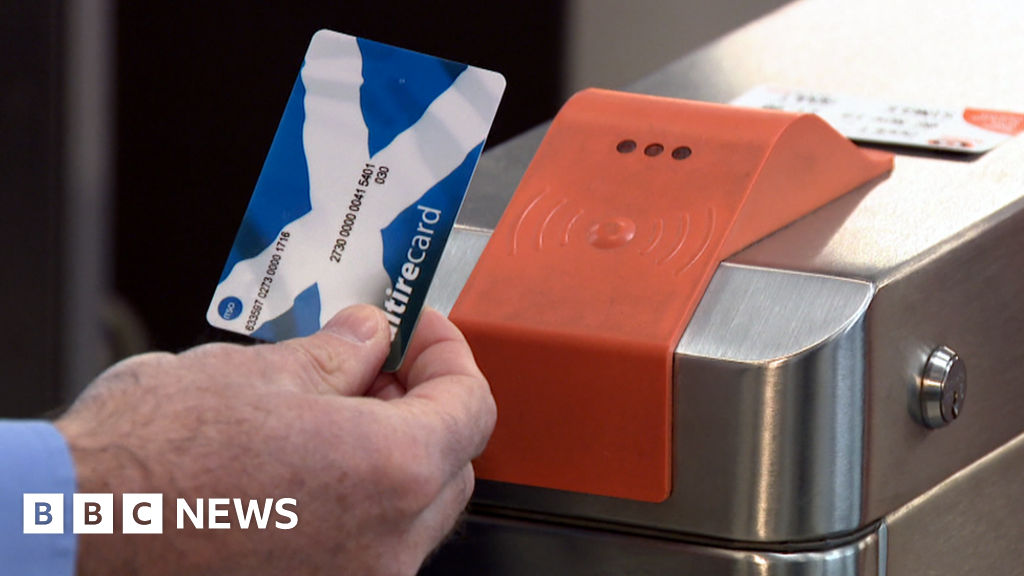 Close up of Michael Matheson, Transport Secretary, using a Scotrail card on the subway