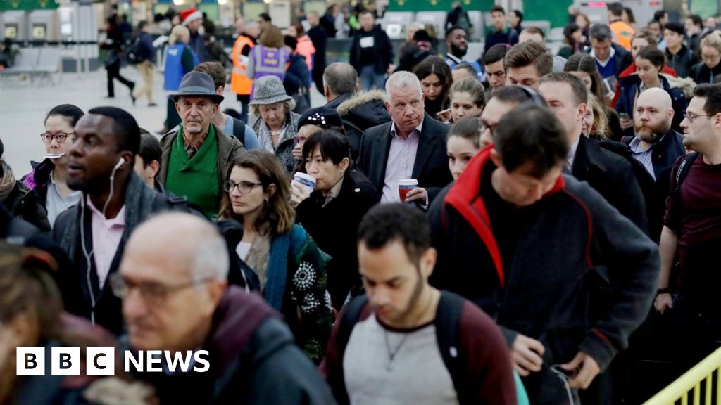 Passengers at London Victoria queue for an express train to Gatwick Airport