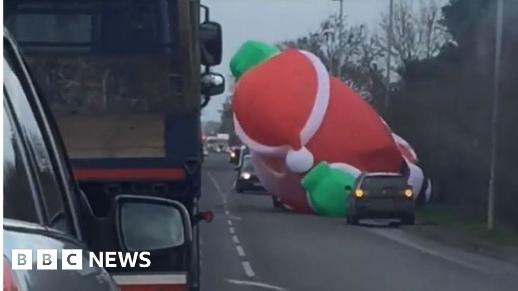 Giant Inflatable Santa Breaks Free To Hold Up Traffic Bbc News