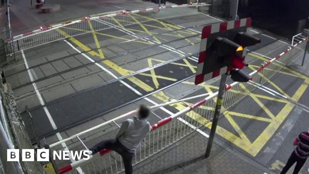 Lincoln CCTV Captures Man's Near Miss At Level Crossing - BBC News