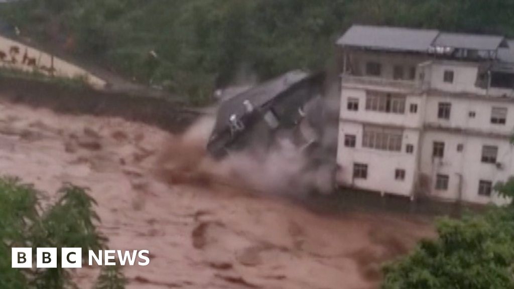 Building collapses into raging China floodwaters