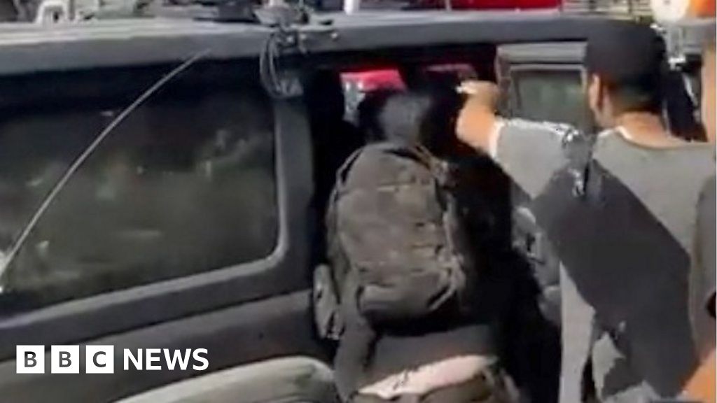 Moment after Israeli hostage pushed into car