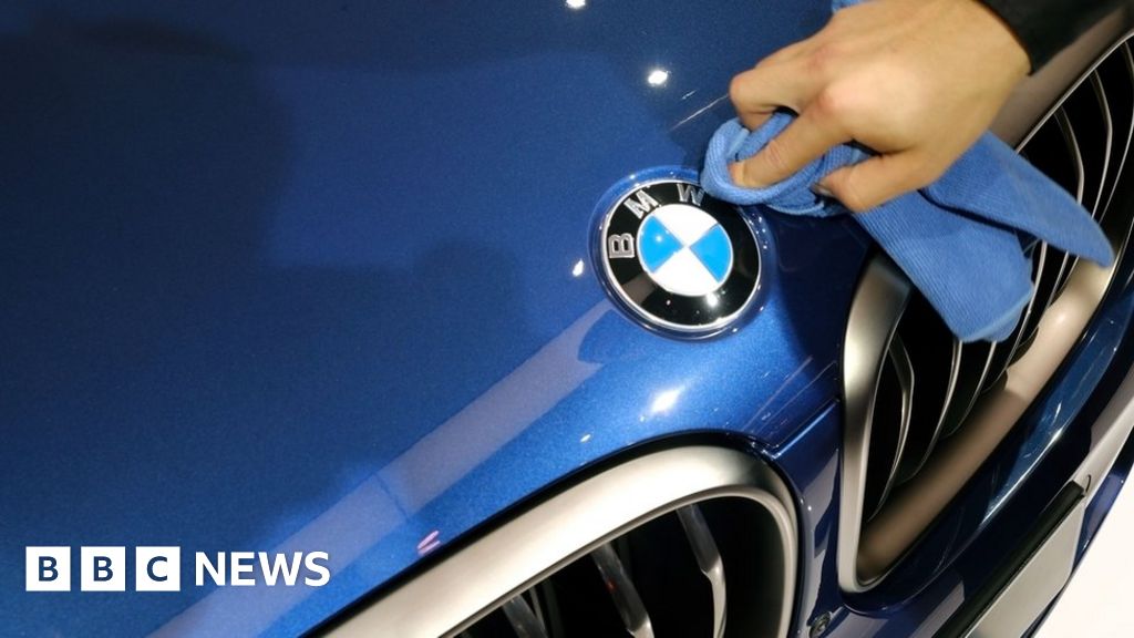 LONDON, UK - October 26th 2018: Hand holding a BMW logo. BMW is an  automobile manufacturer. Stock Photo