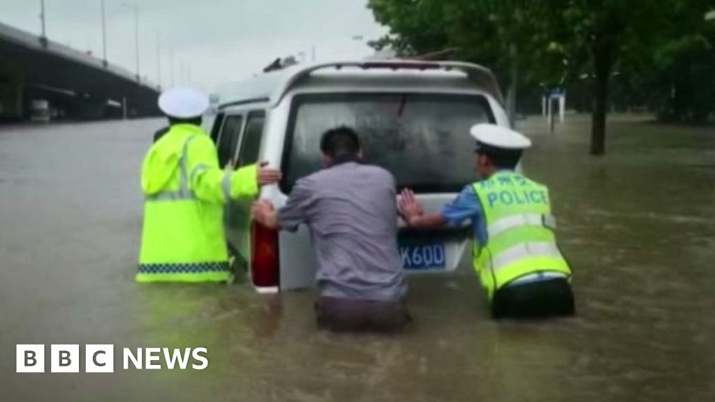 China floods: Passengers stuck in waist-high water on train