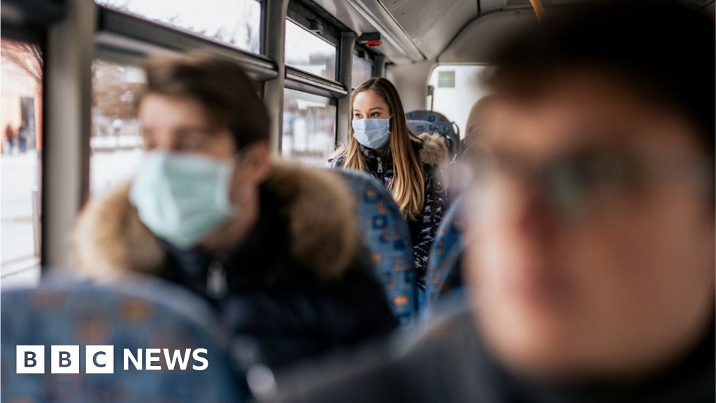 passengers wearing masks on a bus