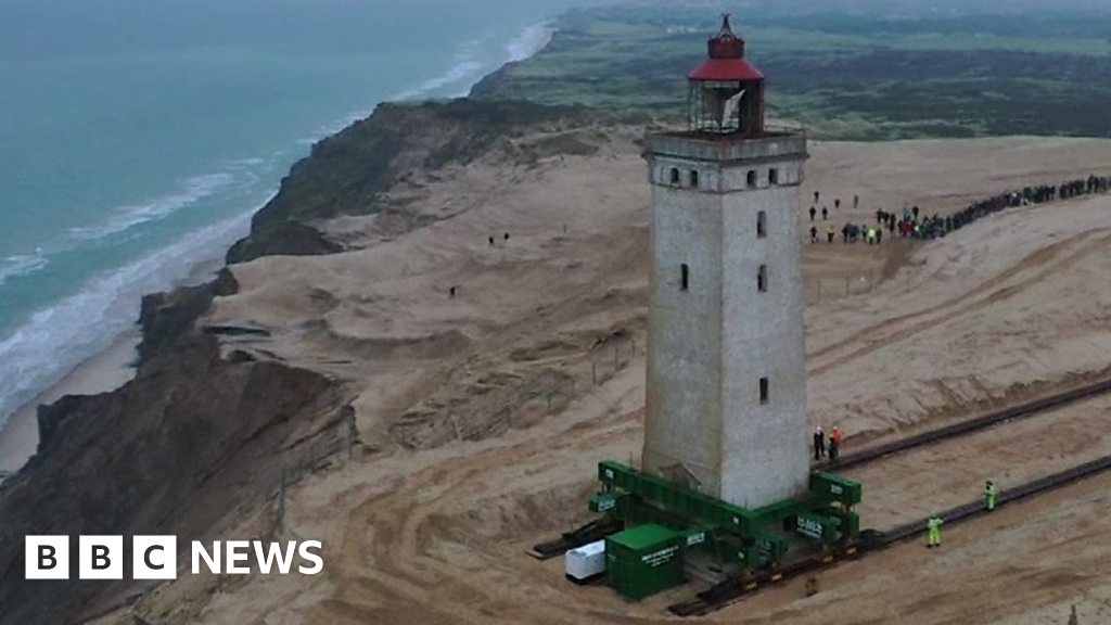 Lighthouse moved 70m on rails to save it from falling into sea