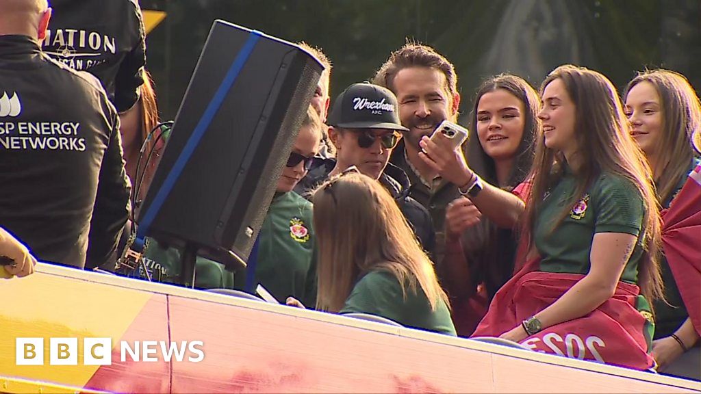 Wrexham: Ryan Reynolds and Rob McElhenney take photos on bus