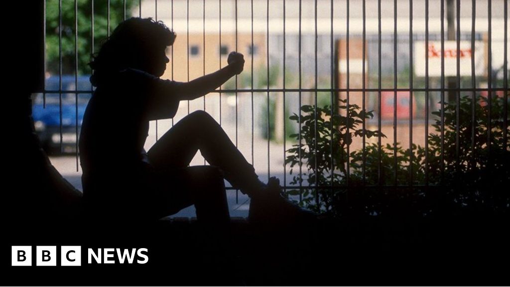 Young girl in silhouette by railings