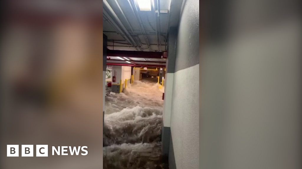 Dramatic moment as water rushes into Florida parking garage