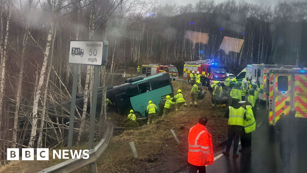 Two in hospital after bus crashes down embankment on A9