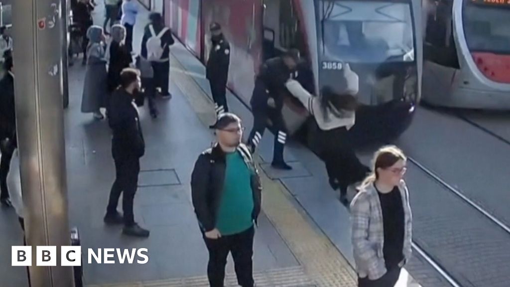 Watch: Moment security guard saves woman from being hit by tram