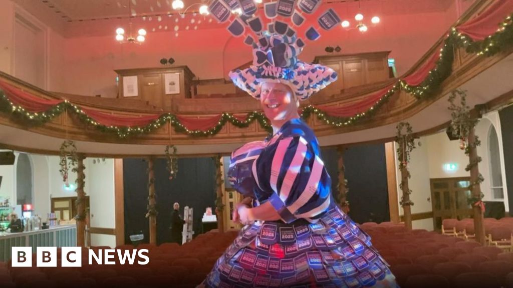 Panto Dame flaunts dress made of manifestos