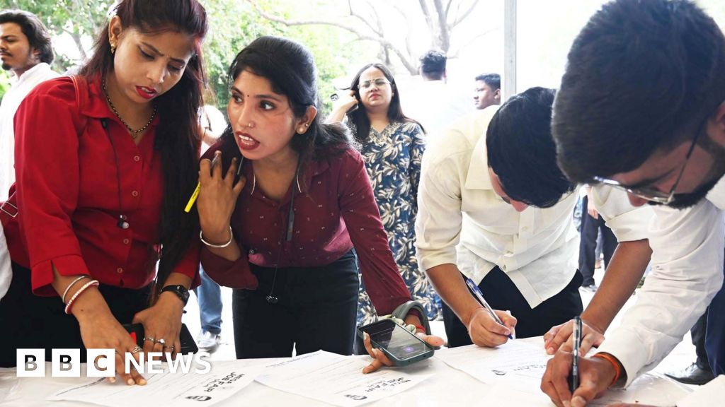 Young people in India waiting outside a job fair