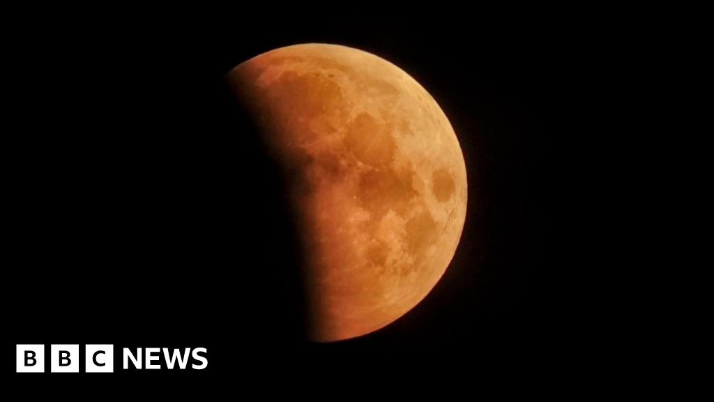 In pictures: Stargazers marvel at 'blood moon' amid lunar eclipse