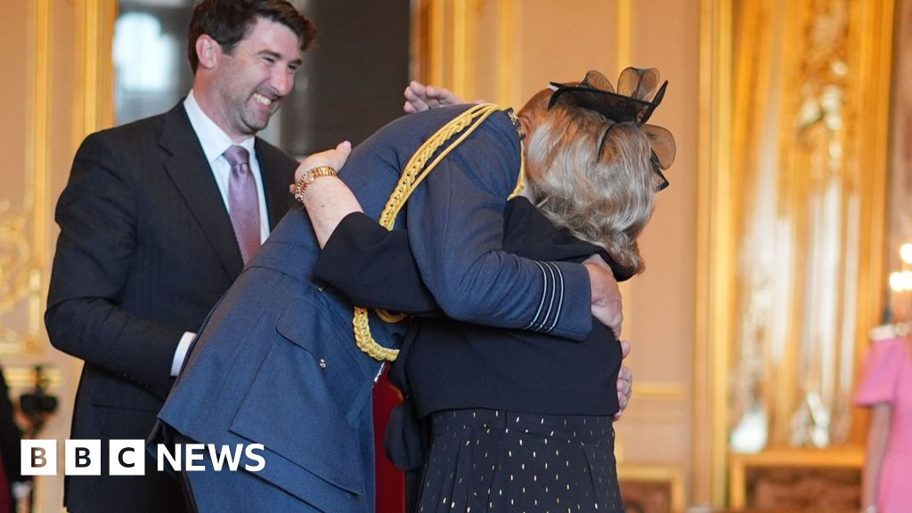 Deaf teacher hugs Prince of Wales at OBE ceremony