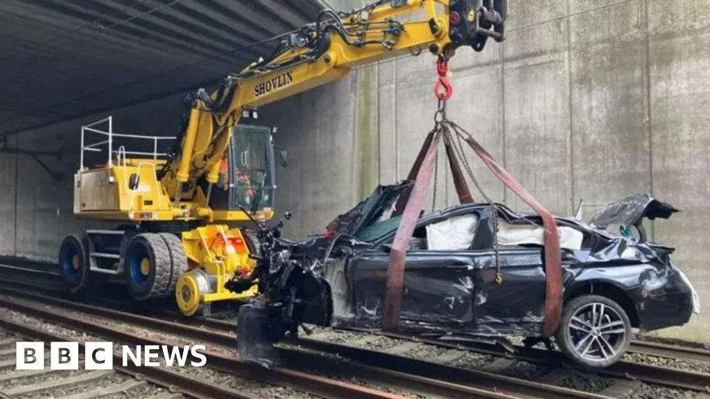 Driver hospitalized after Salford railway crash disrupts services