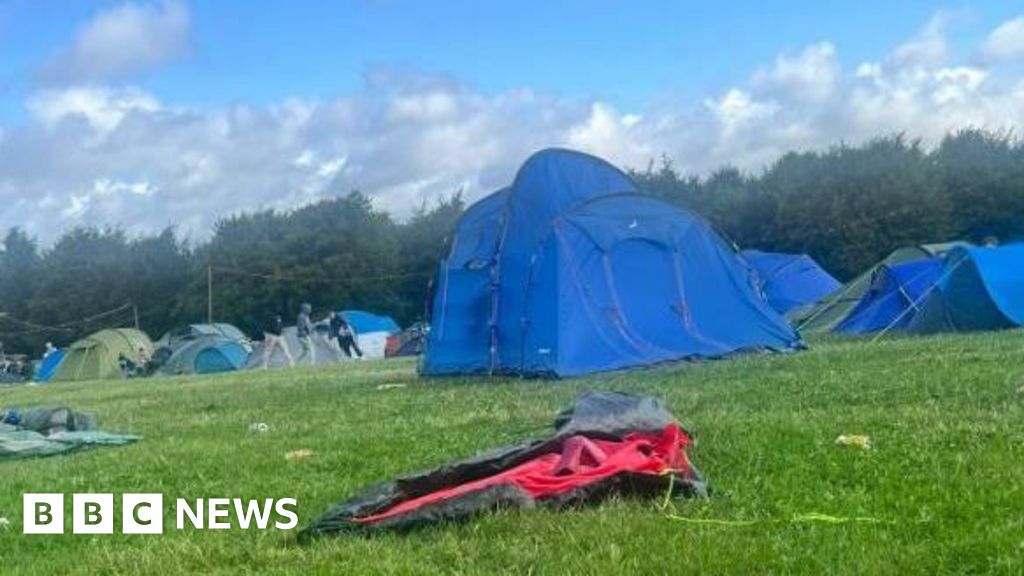 Festival-goers leave as tents and urinals blow away