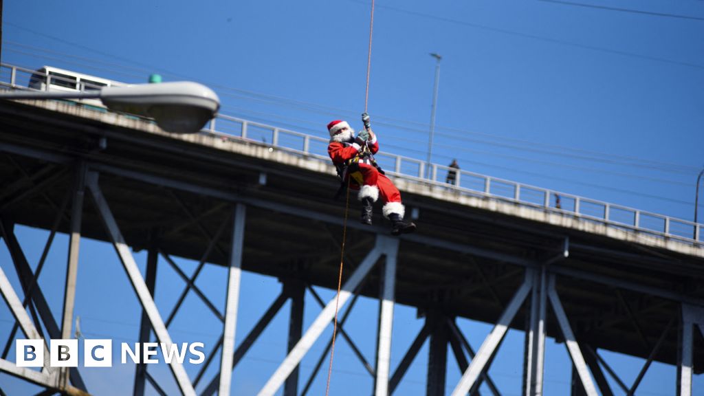 Watch: Abseiling Santa descends from Guatemala bridge to deliver toys