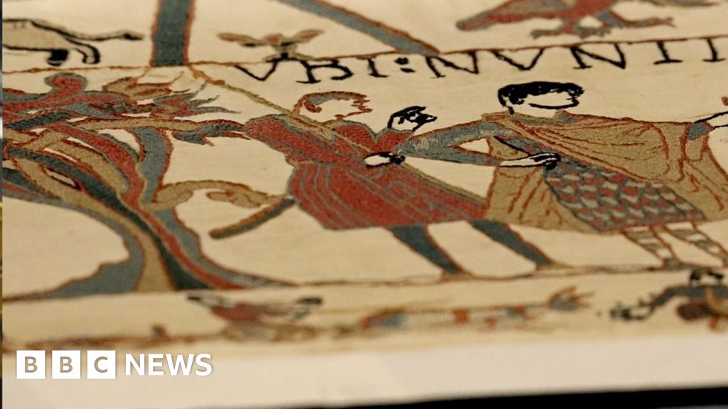 Donning protective kit for a first glance at the Bayeux Tapestry