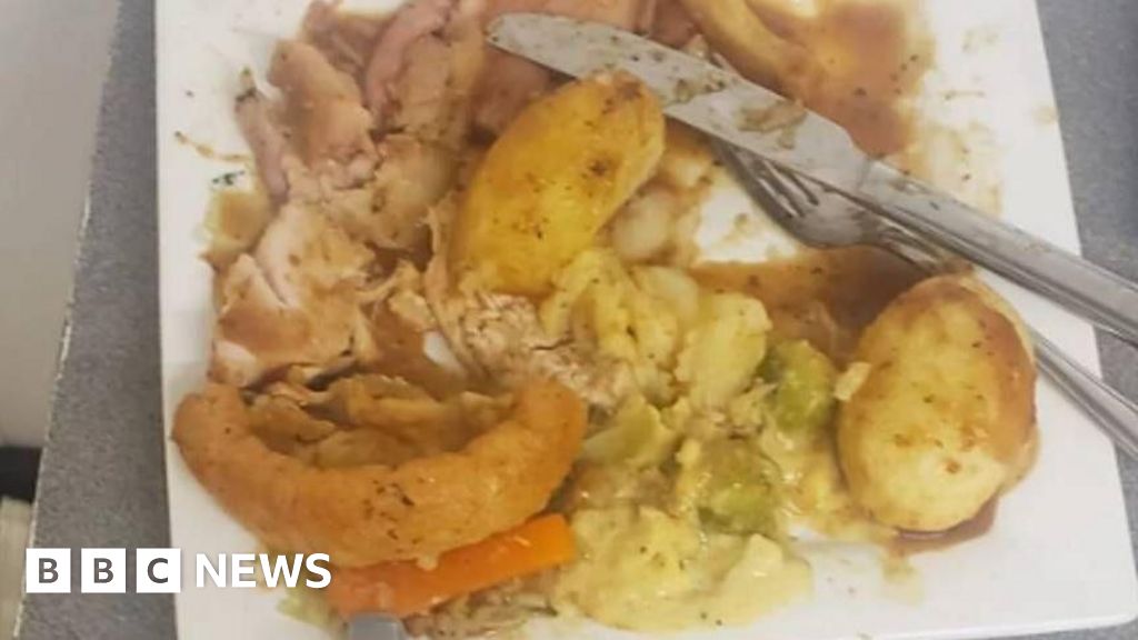 Food left by customer at the Star Inn Vogue in St Day. The partially-eaten square plate looks about three-quarters full, containing some poultry, roasted vegetables and half a Yorkshire pudding. A knife and fork are placed near the remaining food.