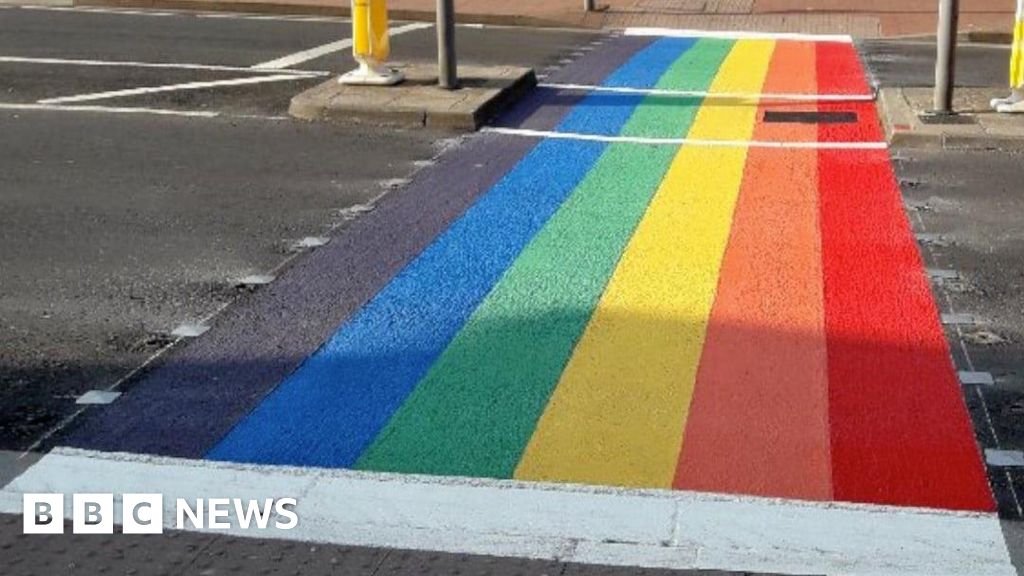A rainbow flag crossing