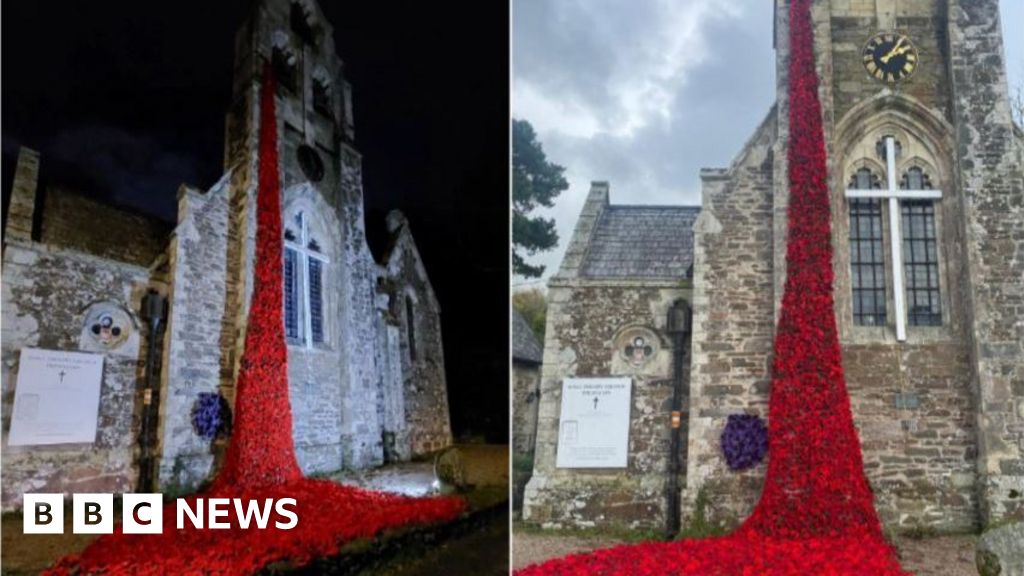 Cascade of knitted poppies draped from Cornish church