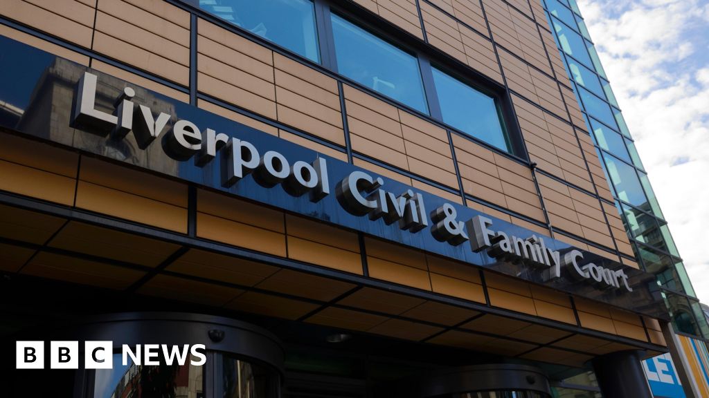 A tall brown building with the lettering "Liverpool Civil & Family Court"
