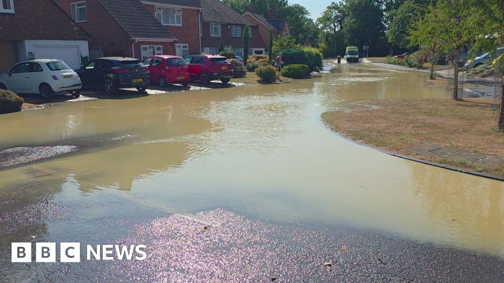 Photo: BBC A flooded residential road