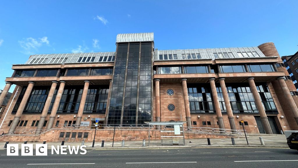 Newcastle Crown Court - a large building with red brick walls and columns and large dark windows