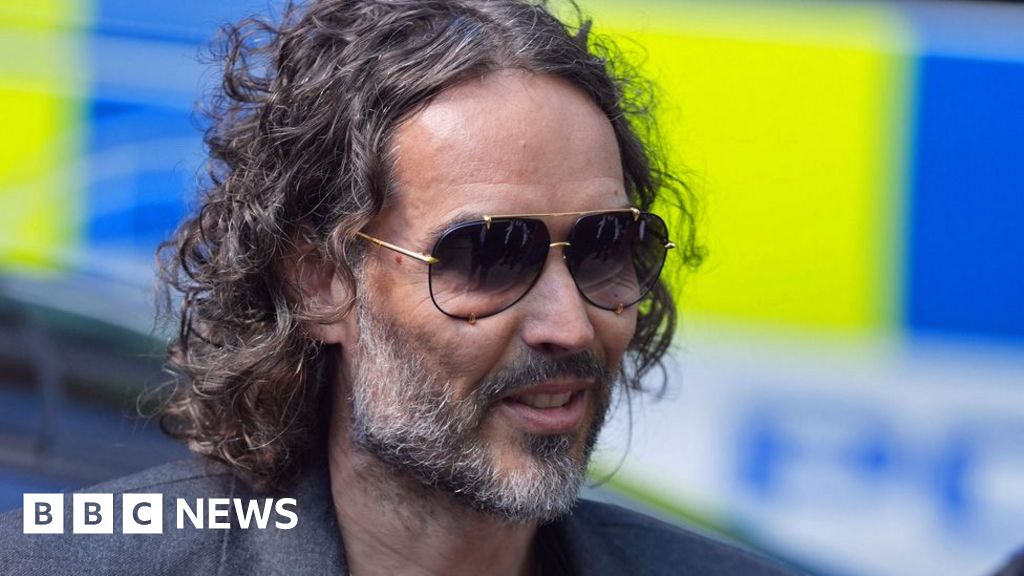 Russell Brand arrives at court to answer rape and assault charges