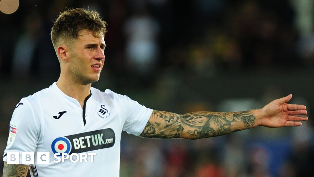 A detailed view of Joe Rodon of Wales tattoos as he speaks to the