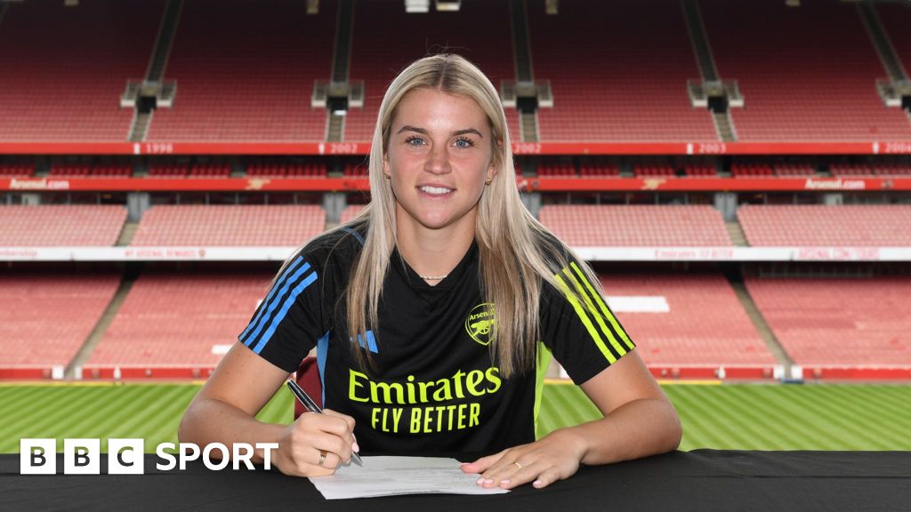 Cloe Lacasse poses as she signs for Arsenal at Emirates Stadium on