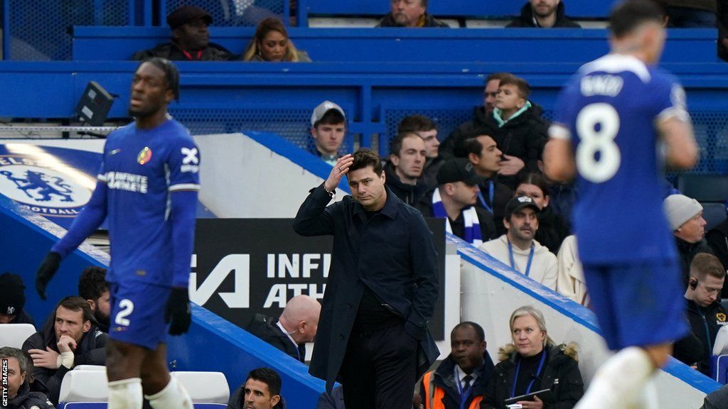 Pochettino holds his hand to his head on the touchline
