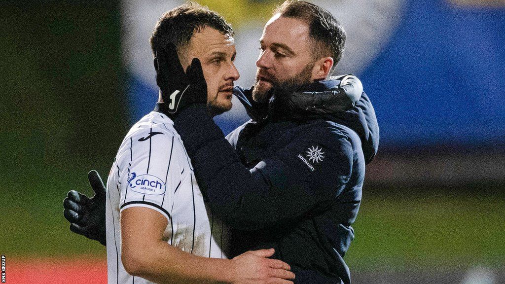 Dunfermline manager James McPake embraces his defender Kyle Benedictus