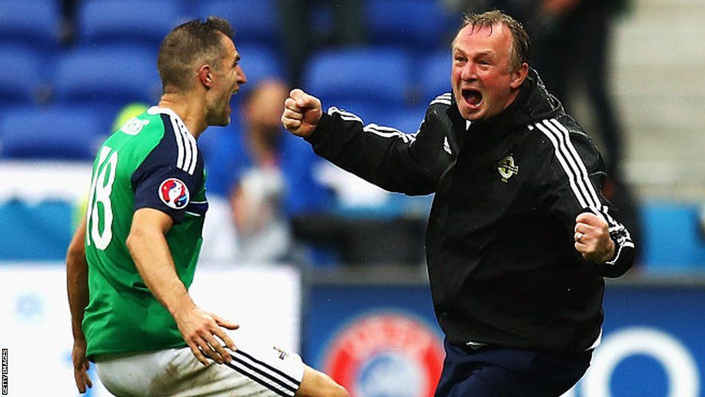 Aaron Hughes celebrates his team';s second goal in the 2-1 win over Ukraine at Euro 2016 with NI manager Michael O'Neill