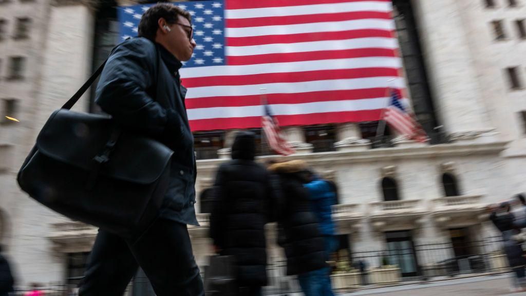 People walk by the New York Stock Exchange (NYSE) on February 20, 2025 in New York City.
