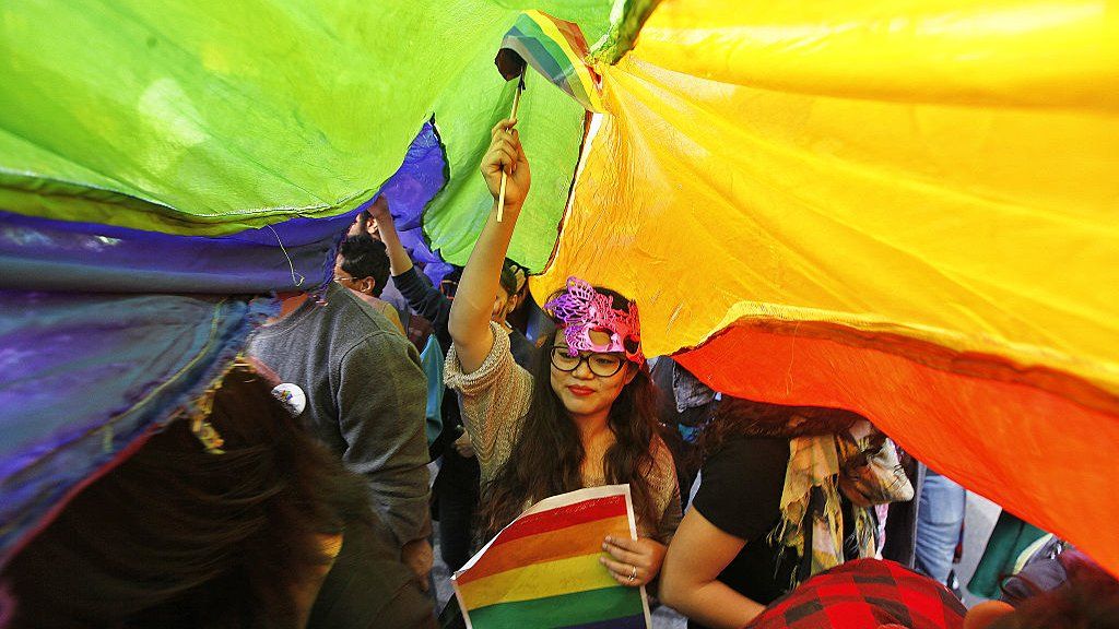 A LGBT rights activist holds rainbow flag during Delhi Queer Pride March from Barakhamba Road to Jantar Mantar on 29 November 2015 in New Delhi, India